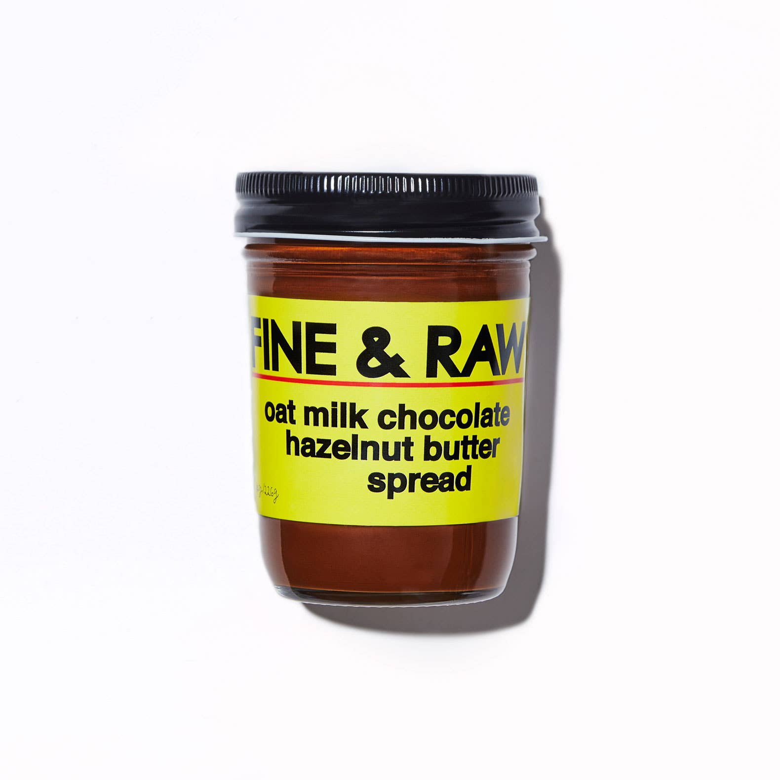 Jar of Fine & Raw oat milk chocolate hazelnut butter spread on a white background