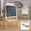 Wooden children's easel with chalkboard and whiteboard surfaces, featuring alphabet and numbers, on a wooden floor.