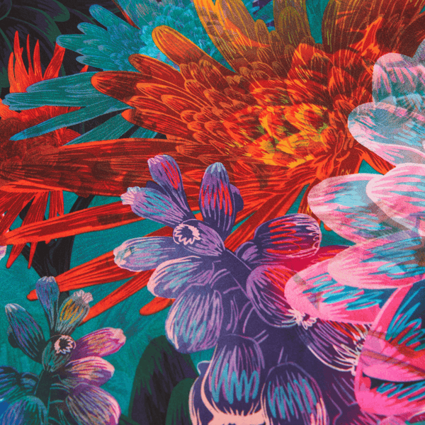 Colorful floral pattern with red, blue, and pink flowers on a green background