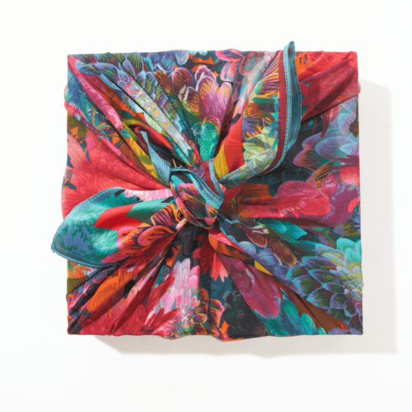 Colorful floral-patterned fabric with a knot on a white background