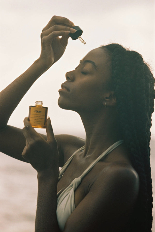 FORAH Dayglow Oil Serum being applied to face, neck and décolleté