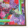 Colorful floral patterned fabric with brand name on a white background