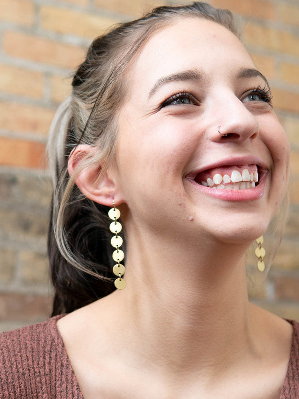 Close-up of Fair Anita disc chain dangle earrings made from upcycled recycled metal