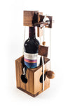 Wooden wine bottle holder with a bottle of red wine inside on a white background