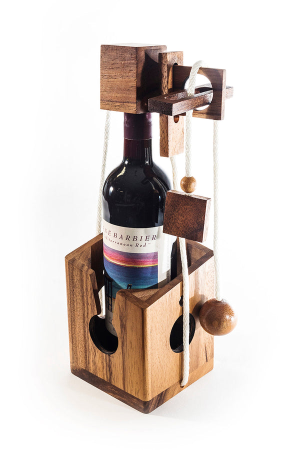 Wooden wine bottle holder with a bottle of red wine inside on a white background