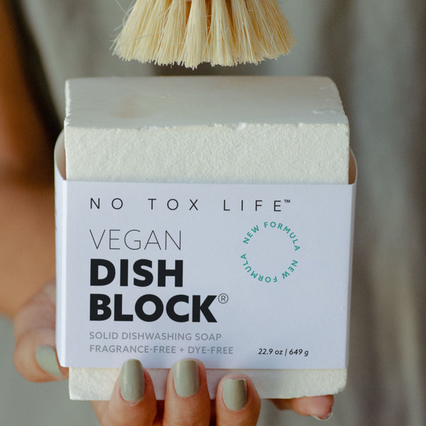 Vegan dish block with a brush held above it, labeled 'No Tox Life'.
