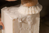 Close-up of a wooden pepper grinder with white pepper on top