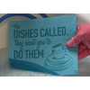 Close-up of the 'Dishes Called' reusable Swedish dishcloth showing bold one-color printed design, 8 x 6.75 inches