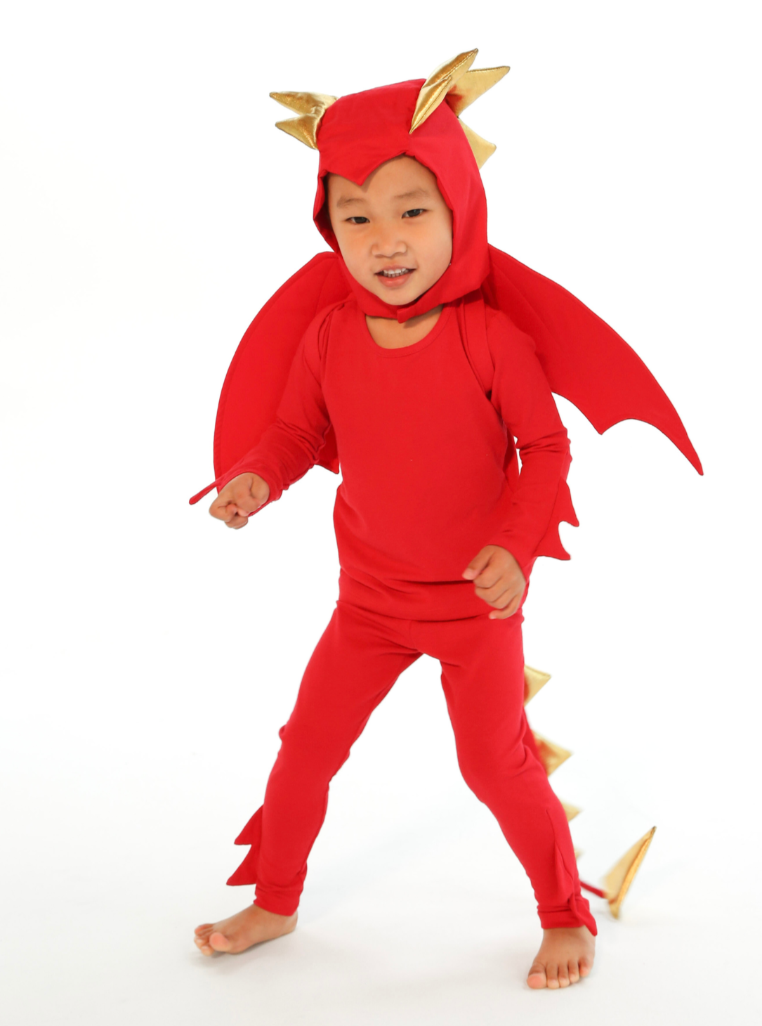 Child wearing a red dragon costume on a white background