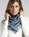 Woman wearing a blue scarf with a white background