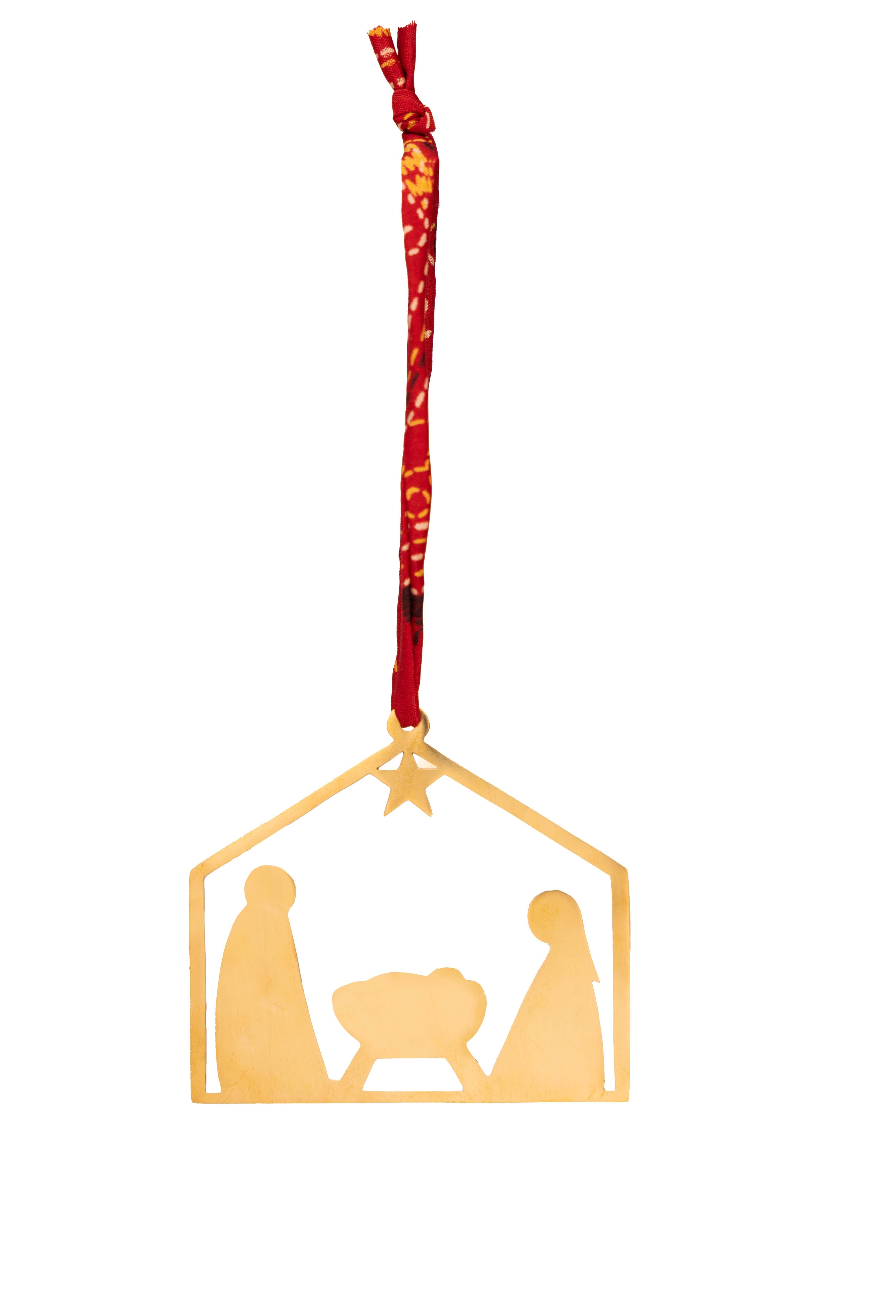Gold nativity scene ornament with red ribbon on a white background