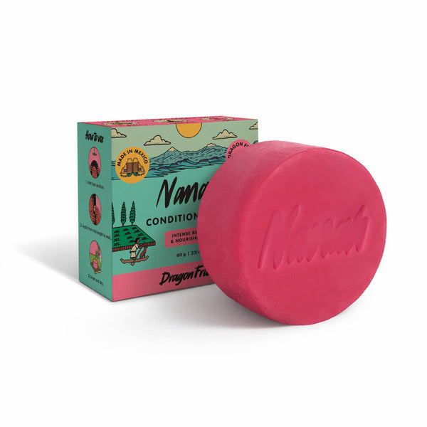 Pink bar of soap with 'Nanoe' branding next to its packaging on a white background. NANAH Dragon Fruit conditioner bar — sulfate-free, repairs dry & damaged hair with organic pitahaya, vitamin B5 & mango butter. Replaces 3 bottles. Shop now.