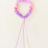 Child wearing Sarah's Silks Blossom Silk Garland on head as a floral headdress for dress-up play