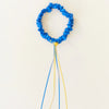 Blue decorative wreath with yellow center on a white background
