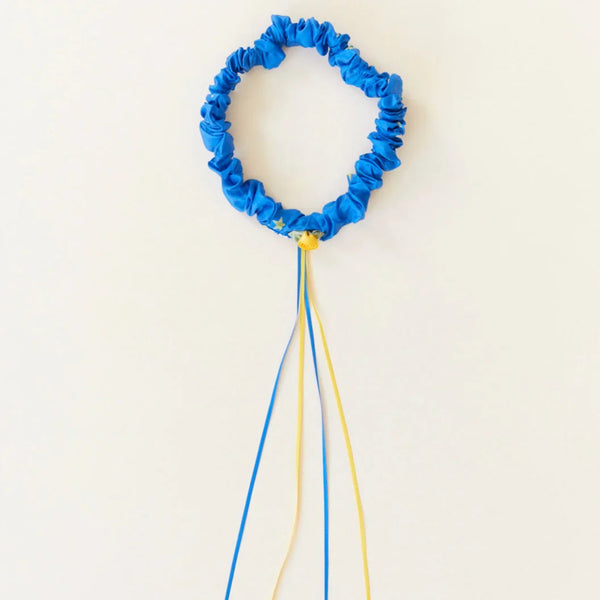 Blue decorative wreath with yellow center on a white background