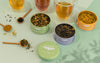 Tea packaging with loose tea leaves on a light surface