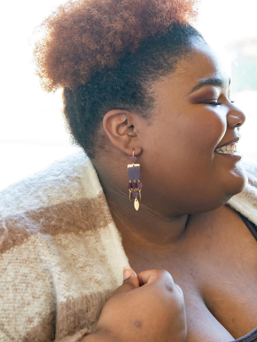Close-up of earthy red brass dangle earrings handcrafted by women artisans in India – Fair Anita