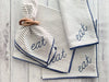 Wood bangle napkin ring styled with striped embroidered dinner napkins on a table setting