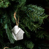 White porcelain hot air balloon ornament with natural jute loop hanging on Christmas tree