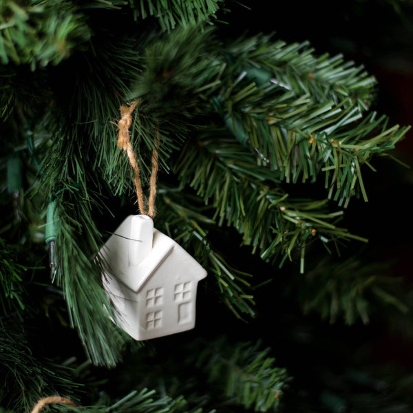 White porcelain hot air balloon ornament with natural jute loop hanging on Christmas tree