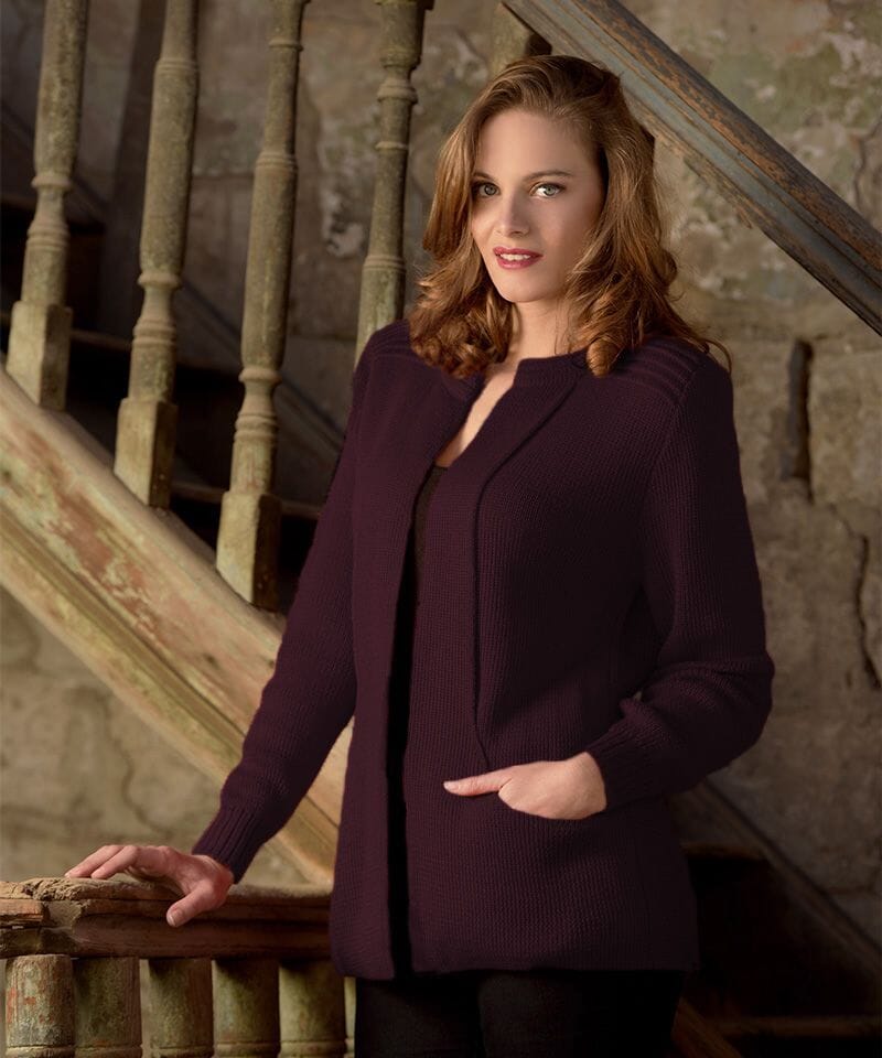 Woman in a purple cardigan standing on a staircase
