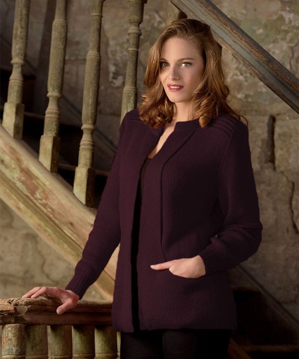 Woman in a purple cardigan standing on a staircase