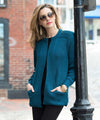 Woman wearing a teal cardigan on a city street