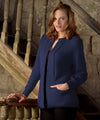 Woman in a blue cardigan standing on a staircase