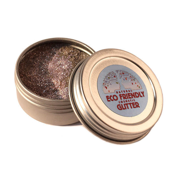 Open container of eco-friendly cosmetic glitter with a visible label on a white background