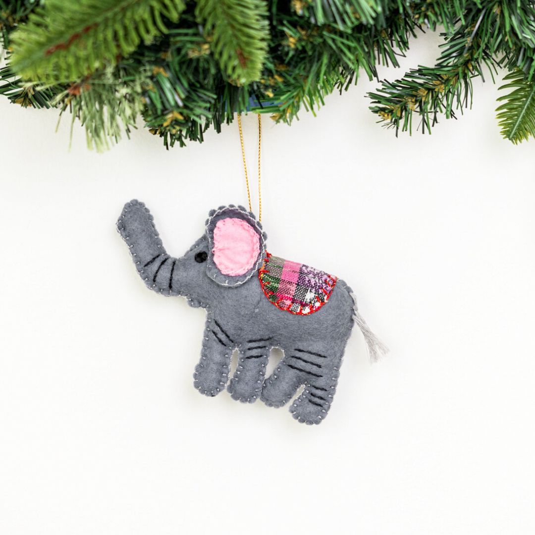 Add a touch of whimsy to your home with our adorable Felt Elephant Ornament. Made from sustainable materials and featuring vibrant colors, this ornament is perfect for children and adults alike. Order yours today!