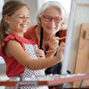 Grandmother and granddaughter painting together