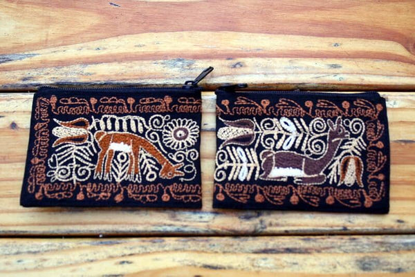 Decorative pouch with animal patterns on a wooden surface