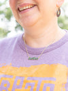 Enameled Justice necklace styled alone showing clean modern word design in dark green enamel