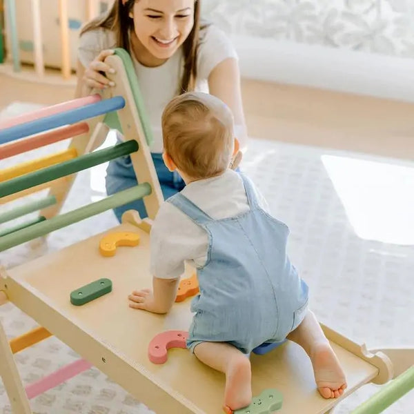 Child climbing on Tiny Land Pikler Triangle Montessori wooden climbing frame in Morandi colours