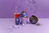 Tea packaging with a glass of tea and loose tea on a purple background