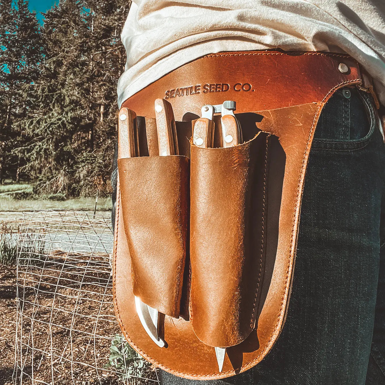 Harvest Essentials leather tool belt laid flat showing adjustable fit and natural leather texture