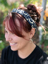 Close-up of blue and cream patterned elastic headband by Fair Anita