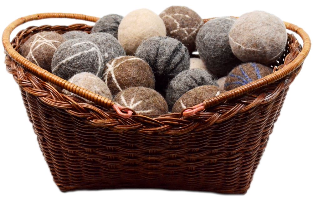 Wicker basket filled with brown and gray stone balls on a white background
