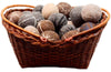 Wicker basket filled with brown and gray stone balls on a white background