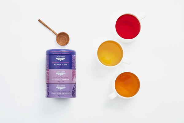 Purple Rain chocolate packaging with three cups of different colored liquids on a white background
