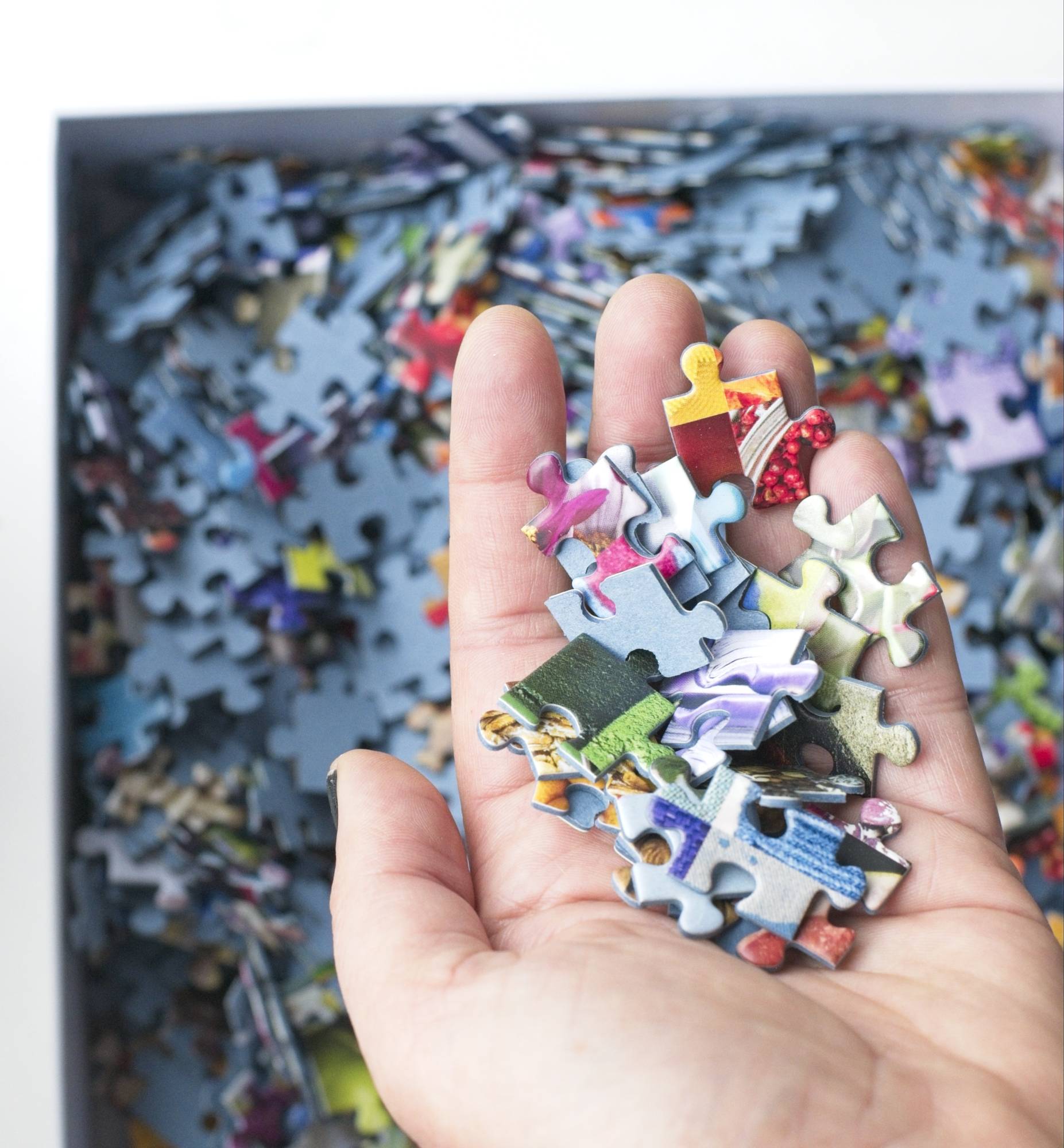 Close-up of ribbon-cut matte puzzle pieces from the 50 Years of Rainbow jigsaw puzzle