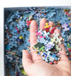 Close-up of ribbon-cut matte puzzle pieces from the 50 Years of Rainbow jigsaw puzzle