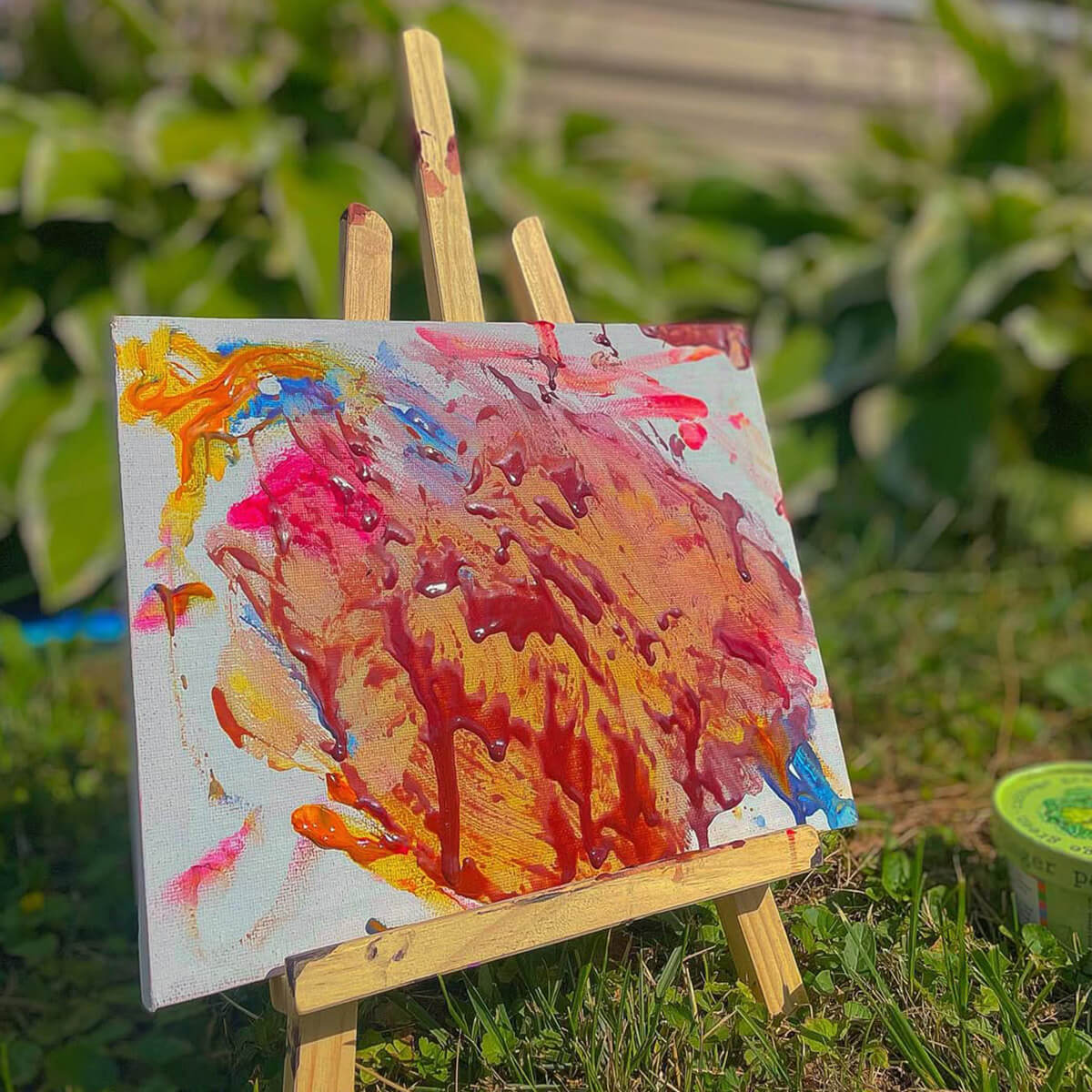 Colorful abstract painting on a small easel outdoors