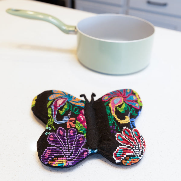 Add a touch of luxury and sustainability to your kitchen with our Brocade Butterfly Pot Holder. Made from upcycled brocade fabric and supporting fair trade practices, this unique pot holder is both stylish and functional. Order yours today!