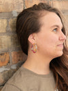 Close-up of Fair Anita resin hoop earrings showing colorful eco-resin detail and texture