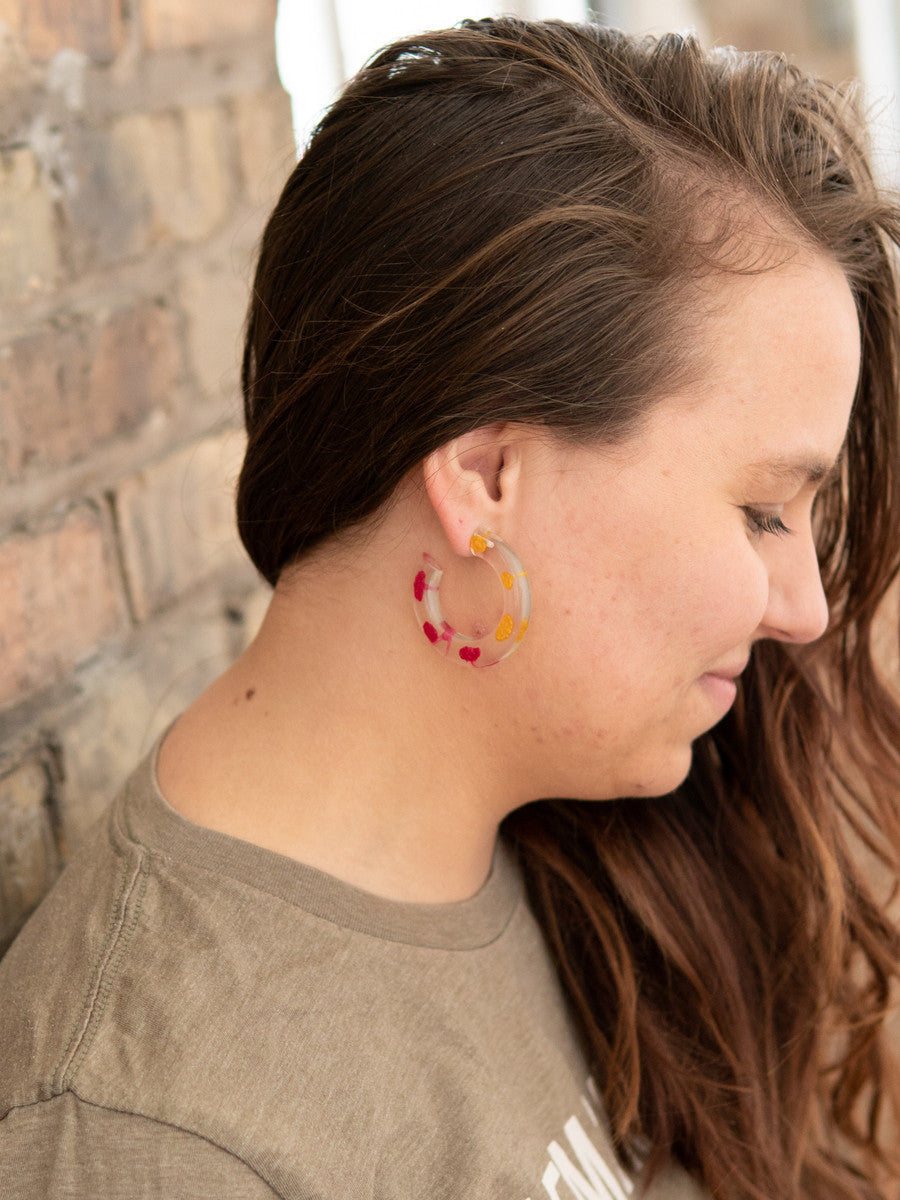 Fair Anita resin hoop earrings worn as a lifestyle shot, showing size and color on model