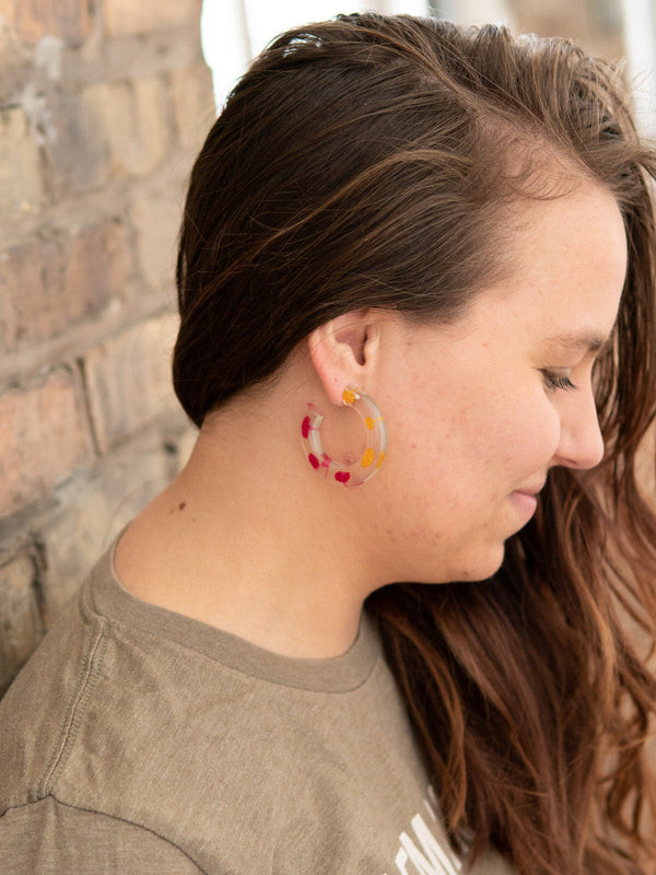 Fair Anita resin hoop earrings worn as a lifestyle shot, showing size and color on model