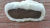 White fuzzy slippers on a wooden surface