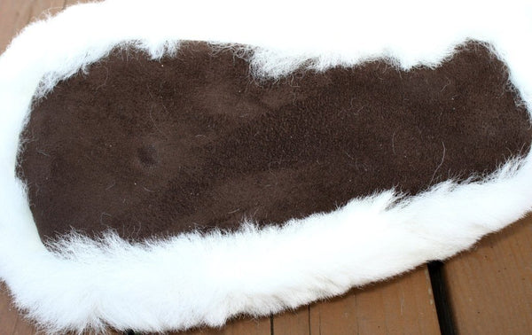 Brown and white fur rug on a wooden floor