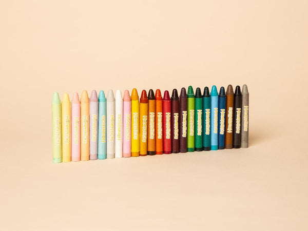 Row of colorful crayons on a beige background